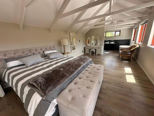 a large bedroom with a large bed and a couch at Barrydale Bliss in Barrydale