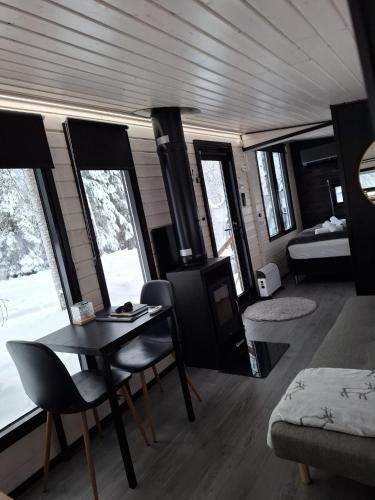 a living room with a table and chairs in a train at Santa Elves Cabin in Rovaniemi