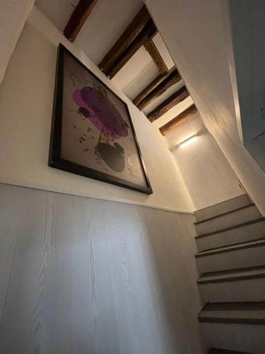 a picture of a bird on the wall of a staircase at Casa rural ‘’La Nuestra’’ in Bercimuel