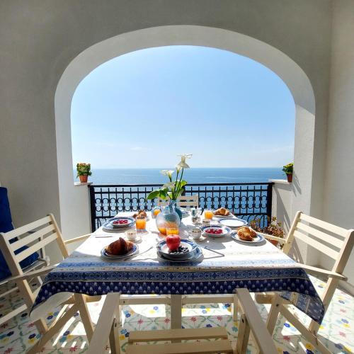a table with food and a view of the ocean at Casa Gianna New 2026 in Praiano