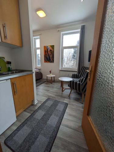 a kitchen and a living room with a table at Wohnung Schlossblick in Celle