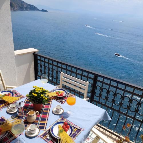 a table with food and a view of the ocean at Casa Gianna New 2026 in Praiano