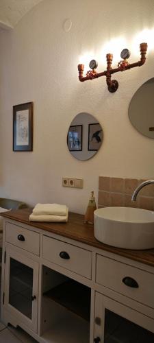 a bathroom with a sink and a mirror at Pension Burgenring in Schlitz