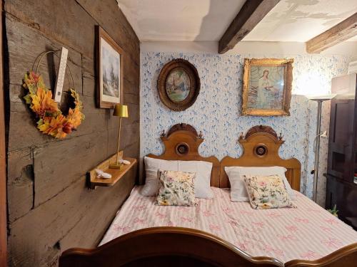 a bedroom with a wooden bed with pillows at Hiža Bake Veronike in Hrašćina