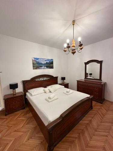 a bedroom with a large bed and a mirror at Apartment Abba in Kali