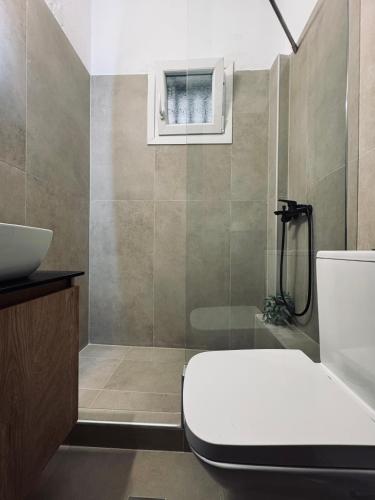 a bathroom with a toilet and a sink at Dolphin in Kavála