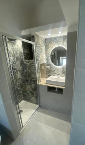 a bathroom with a shower and a sink and a mirror at Le Regioni Del Cuore in Vieste