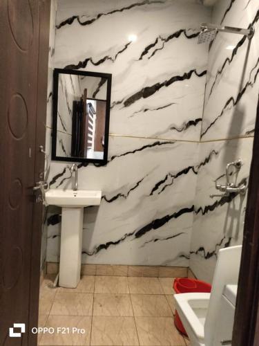 a bathroom with a sink and a mirror at HOTEL SATYA in Dehradun