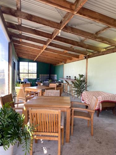 a room with wooden tables and chairs and a room with at Pebble Point in Princetown