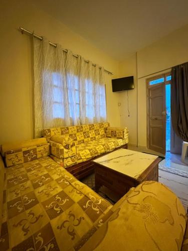 a living room with two beds and a couch at Golden Dunes in Tozeur