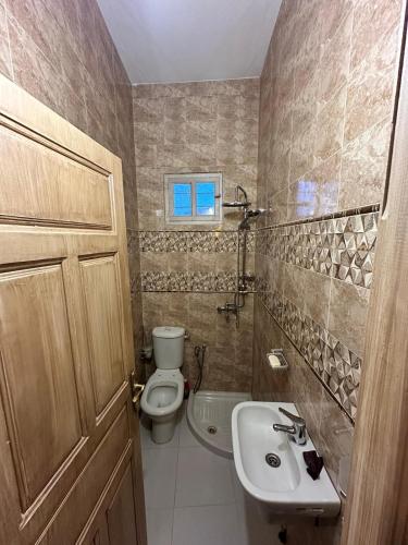 a bathroom with a toilet and a sink at Golden Dunes in Tozeur