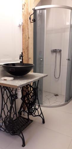 a bathroom with a black sink on a table at Izdebka in Bochowo