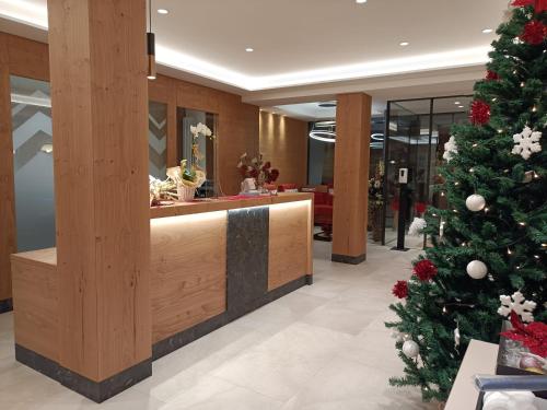 a christmas tree in the lobby of a store at Hotel Canada in Andalo