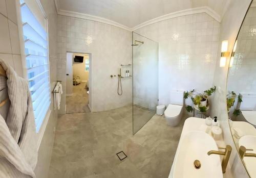 a bathroom with a shower and a sink and a toilet at Bathurst River House B & B in Bathurst
