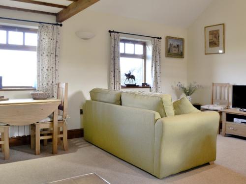 a living room with a couch and a table at Brandy's Barn in Middleham