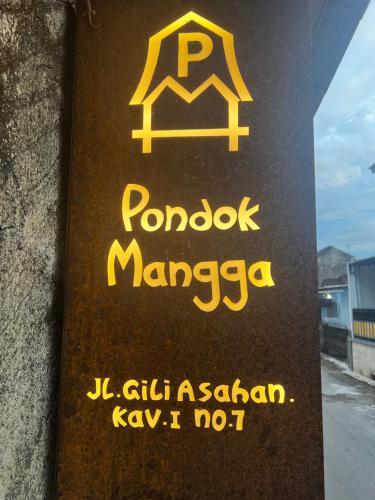 a sign on the side of a building that reads pongot marigua at Pondok Mangga in Mataram