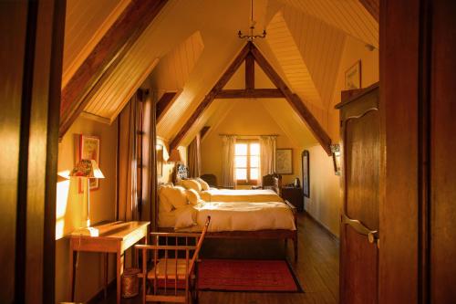 a bedroom with a large bed in a attic at Lokanga Boutique Hotel in Antananarivo