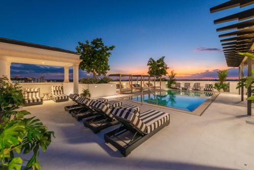 a patio with lounge chairs and a swimming pool at The Avenue Hotel Coral Gables in Miami