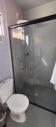 a bathroom with a toilet and a glass shower at Studio Container Morano Calabro in Florianópolis