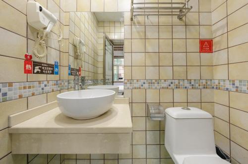 a bathroom with a sink and a toilet at A deer has you INN near by Tianmen Shan--Free pick-up-Aerial Cableway in Zhangjiajie