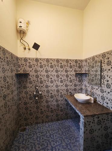 a bathroom with a sink and a toilet in it at Art cafe in Auroville