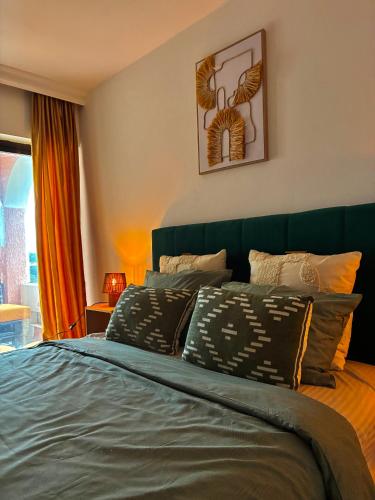 sypialnia z łóżkiem z zielonym zagłówkiem w obiekcie Waves View w Ulcinju