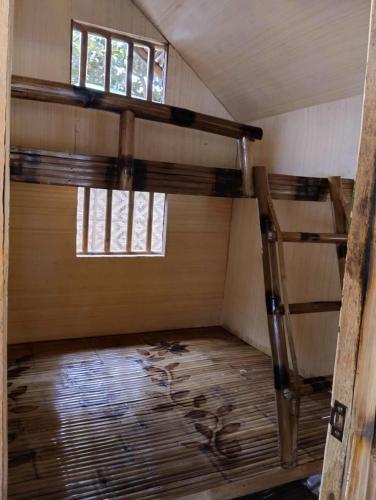 a room with two bunk beds and a window at Rendan Kubo in Batangas City