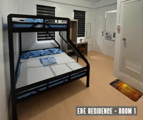 a room with two bunk beds and a bathroom at E&E Residence in Locsin