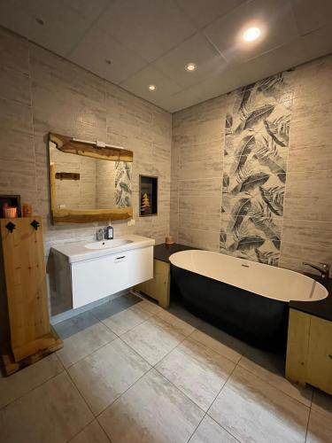 a bathroom with a tub and a sink and a mirror at NEOM DAHAB - - - - - - - - - - - Your new hotel in Dahab with private beach in Dahab