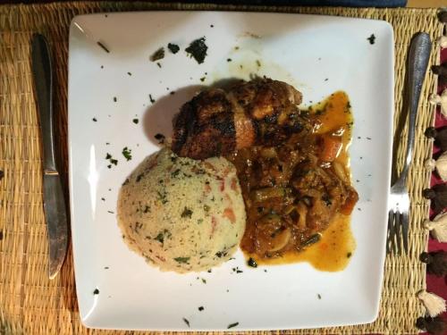 a plate of food with meat and potatoes on a table at Auberge La Fibule Du Dades in Aït Idaïr