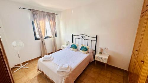 a bedroom with a bed with two towels on it at Apartamentos Ajabo Adeje in Adeje