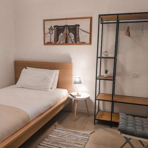 a bedroom with a bed and a book shelf at Mentana Guest House in Parma
