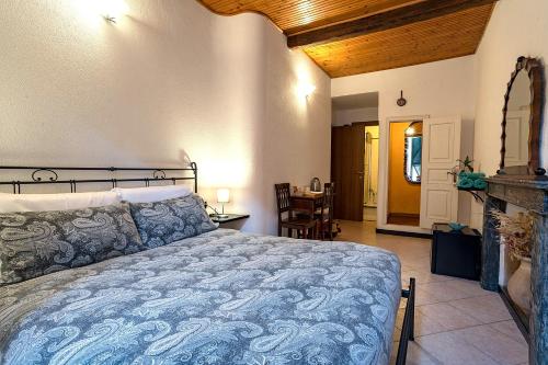 a bedroom with a bed with a blue comforter at Macaia Village Life Room with AC #1 in Vernazza