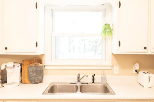 a kitchen counter with a sink and a window at The Tackle Box in Guntersville