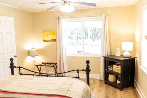 a bedroom with a bed and a window at The Tackle Box in Guntersville