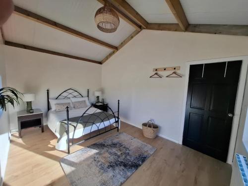 a bedroom with a bed and a black door at Countryside Cabin in Charlestown