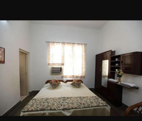 a bedroom with a large bed and a window at Chaudhary dharamshala in Jāmb