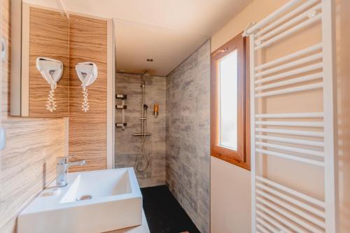a bathroom with a sink and a shower at Kon Tiki in Saint-Tropez