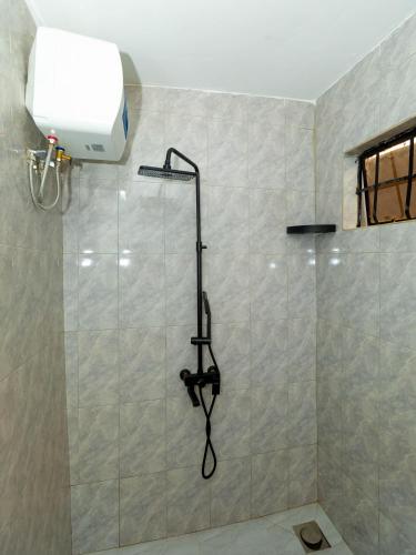 a bathroom with a shower with a shower head at Msafiri Haven in Moshi