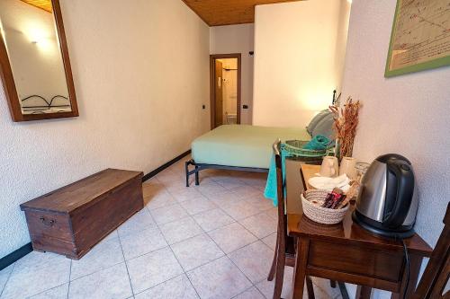 a room with a bed and a table with a television at Macaia Village Life Room with AC #2 in Vernazza