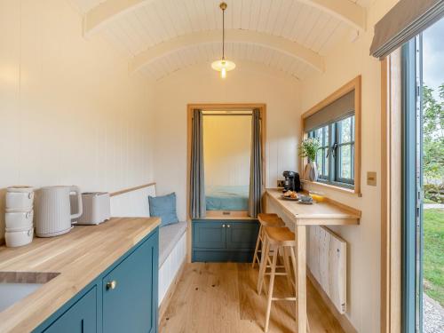 a kitchen with blue cabinets and a counter top at Shepherd's Retreat in Ongar