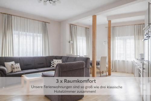 a living room with a couch and a table at Haus Repin, Oberhof, historische Villa am Rennsteig, Thüringer Wald in Oberhof