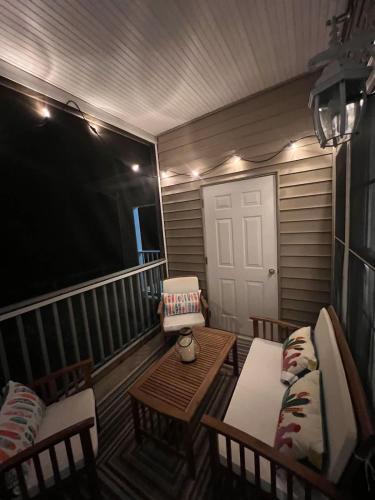 a room with a porch with a table and chairs at Family perfect getaway 2 bedroom apartment in Rehoboth Beach