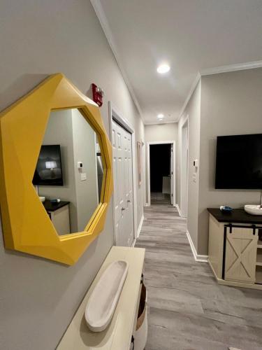 a room with a yellow mirror on the wall at Family perfect getaway 2 bedroom apartment in Rehoboth Beach