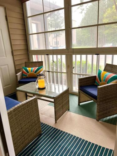 a screened in porch with chairs and a table at Beach perfect getaway 2 bedroom apartment in Rehoboth Beach