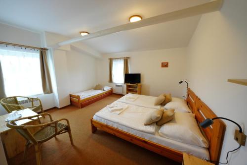 a bedroom with a large bed in a room at Resort Ohrada in Vísky