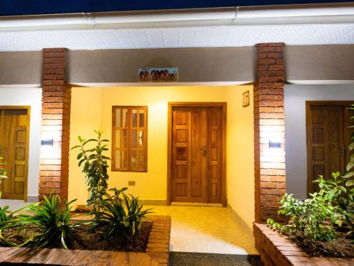 a house with yellow walls and wooden doors at Msafiri Haven in Moshi