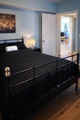 a bedroom with a large black bed in a room at Robertson Homes of Love in Los Angeles