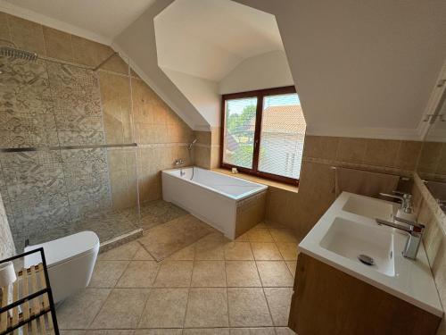 a large bathroom with a tub and a sink at Vianelli apartman in Zamárdi