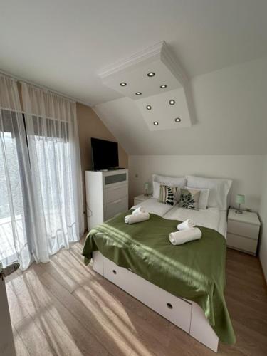 a bedroom with a bed with two towels on it at Vianelli apartman in Zamárdi